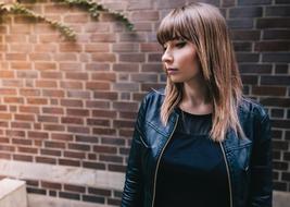 portrait of Girl near brick wall