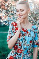 girl in a colorful dress posing in the garden