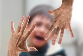 hands as a symbol of violence on a blurred background