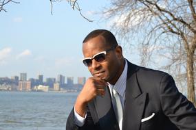 young african american businessman near water in new york