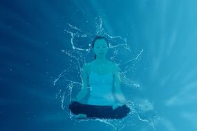 Meditation, girl in lotus pose at blue background