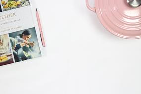 a book with a picture of Meghan Markle near the pink pans