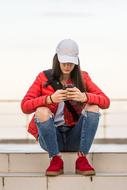 girl with a phone on the steps