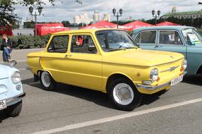 old yellow car in the parking lot