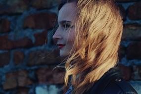 profile photo of a blonde girl on a brick wall background