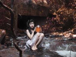 Girl Sitting near water Stream