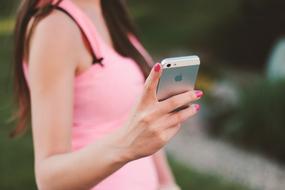 Smartphone hand pink dress