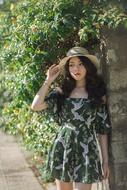 young asian woman in hat posing on a sunny day