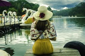 young girl in a hat on the embankment