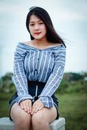 Asian woman in striped shirt among nature