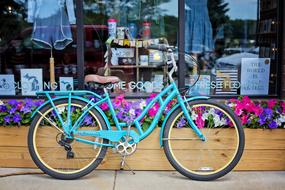 Turquoise Vintage Bicycle parked at shop display