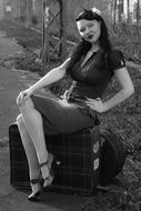 woman with luggage in pin up style