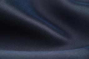 Close-up of the beautiful, dark blue fabric with weaving