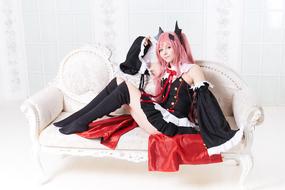 a girl in a anime costume is lying on a pink sofa