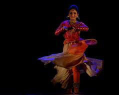 Beautiful and colorful, smiling Indian dancer woman, at black background