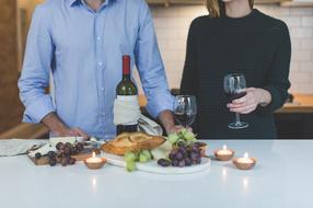 Man and woman on the romantic dinner with wine and candles