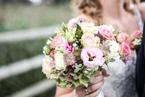 bridal bouquet in hands close up on blurred background