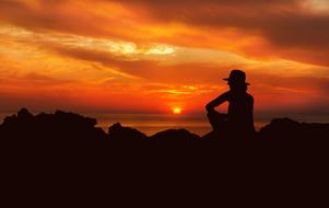 Silhouette of Woman on seaside at Sunset