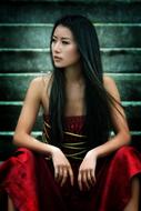 photo of asian model sitting on the steps