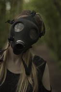 photo of a girl in a black gas mask