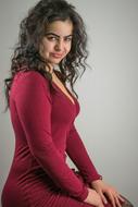 woman in a burgundy dress at a photo shoot