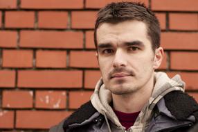 portrait of a handsome guy on a brick wall background