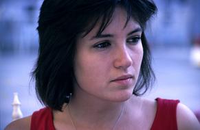 girl in a red t-shirt with pensive eyes