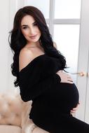 Woman pregnant black dress