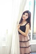 fashionable asian girl posing near the window