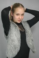 young woman in grey vest