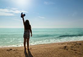 silhouette of a woman on the beach on a sunny day