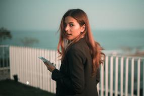 beautiful girl with phone on blurred background