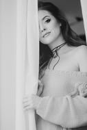 Portrait of a girl, posing near the white curtain
