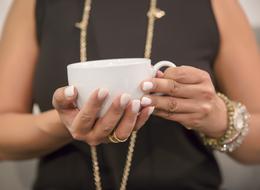 woman hands holding coffee cup