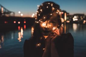 Girl with lights on head at dusk