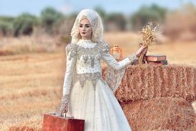 vintage female figure in bridal dress on the field