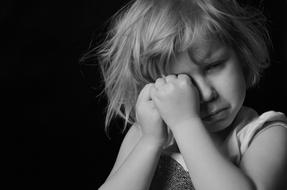 black and white photo of a lonely little girl