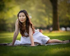 attractive asian Woman on lawn in park