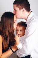 Family, with the baby, kissing each other