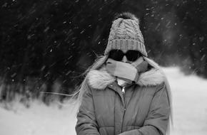 girl in black glasses in the snow