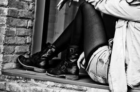 woman in black boots posing at the window