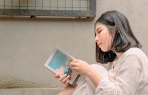 girl on the street with a book in her hands