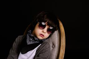 boy in fashionable clothes and sunglasses