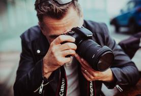 man with camera on blurred background