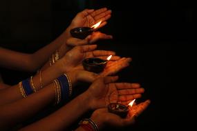 candles on woman hands