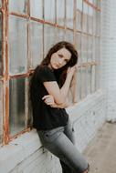 model posing near the window of an old building