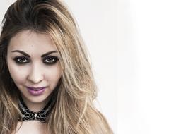 Portrait of the blonde girl, with the colorful make-up and accessory, at white background