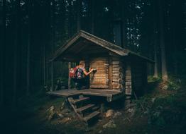 girl opening door of Cabin in Forest