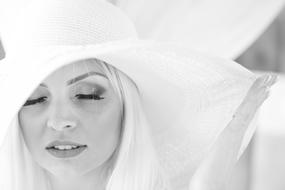 black and white portrait of a girl with white hair wearing a hat