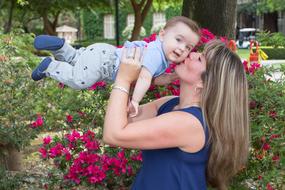 woman kissing baby